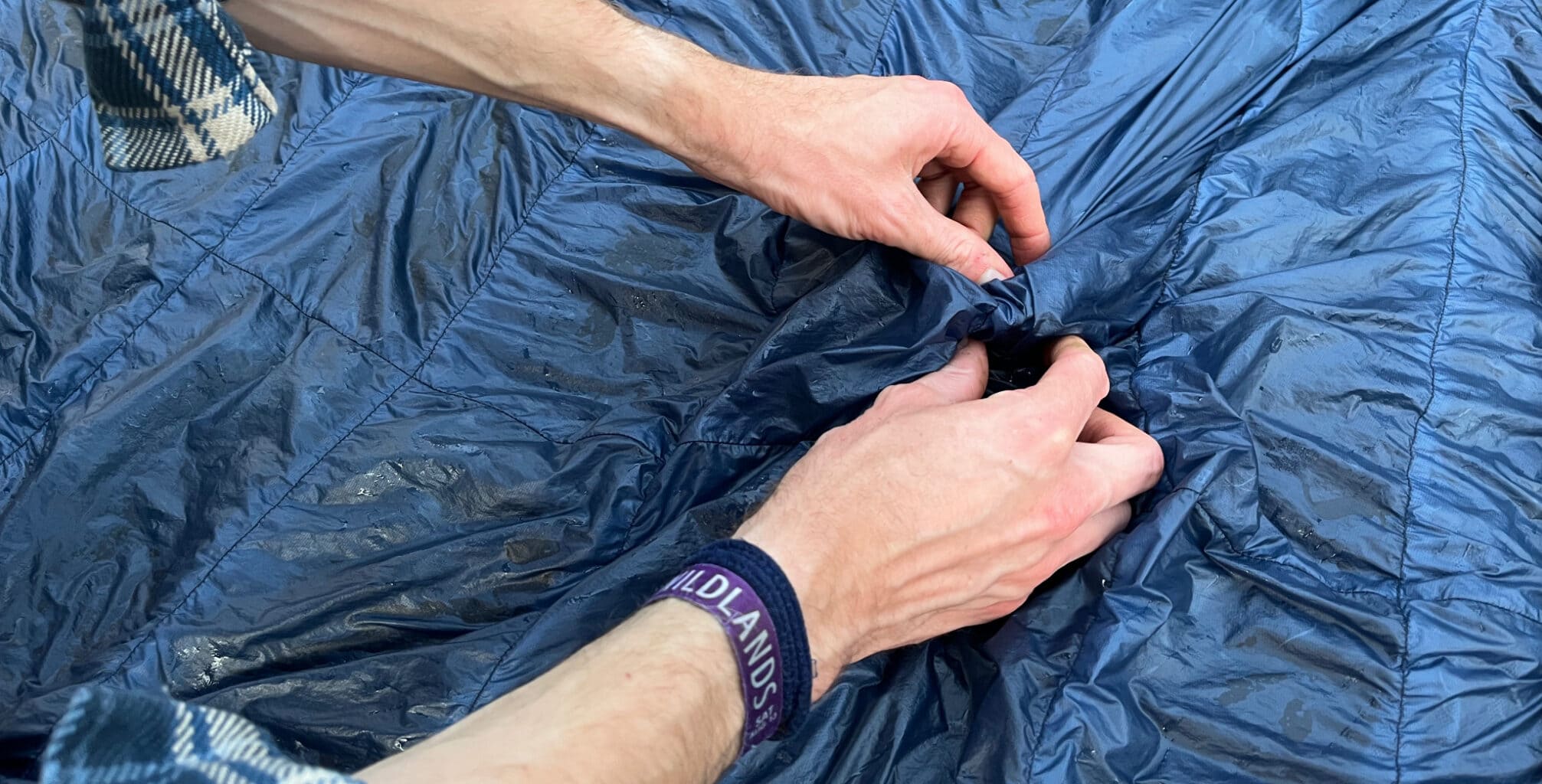 separating clumps of down in a down sleeping bag by hand