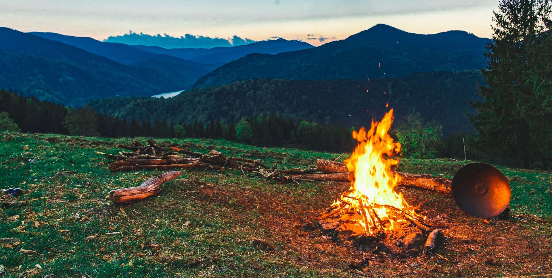 Campfire Burning In Front Of Mountains