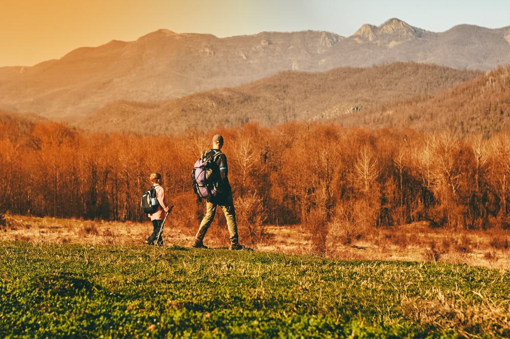 A father and son hiking surrounded by mountains 