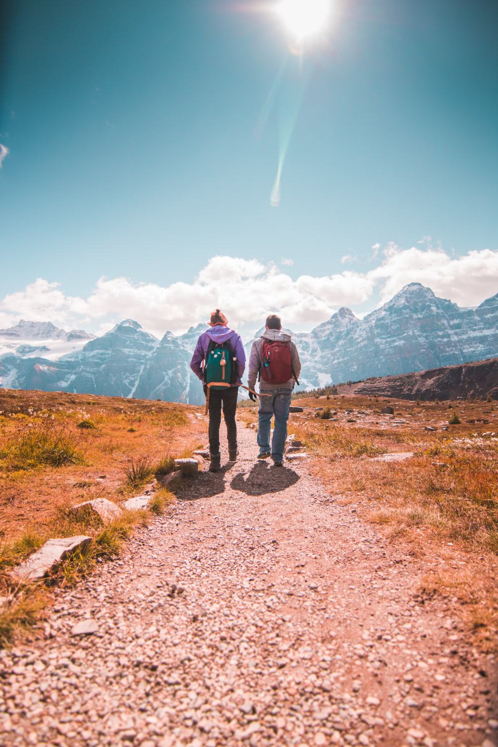 Two people hike along a path