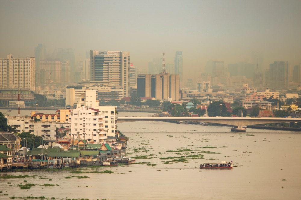 A city covered in thick smog, limiting visibility