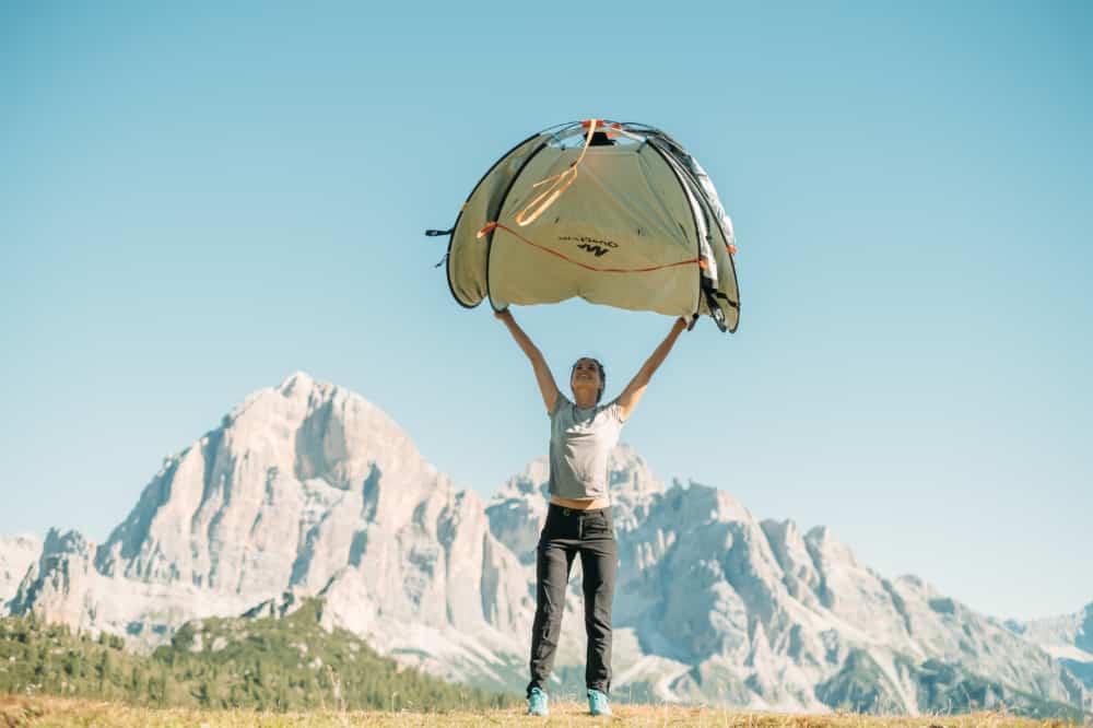 A woman popping open the Quechua instant tent