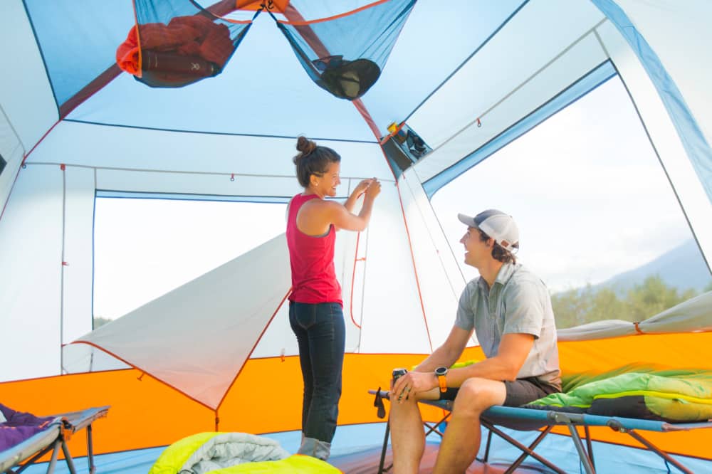 Two campers inside their Eureka Copper Canyon cabin tent