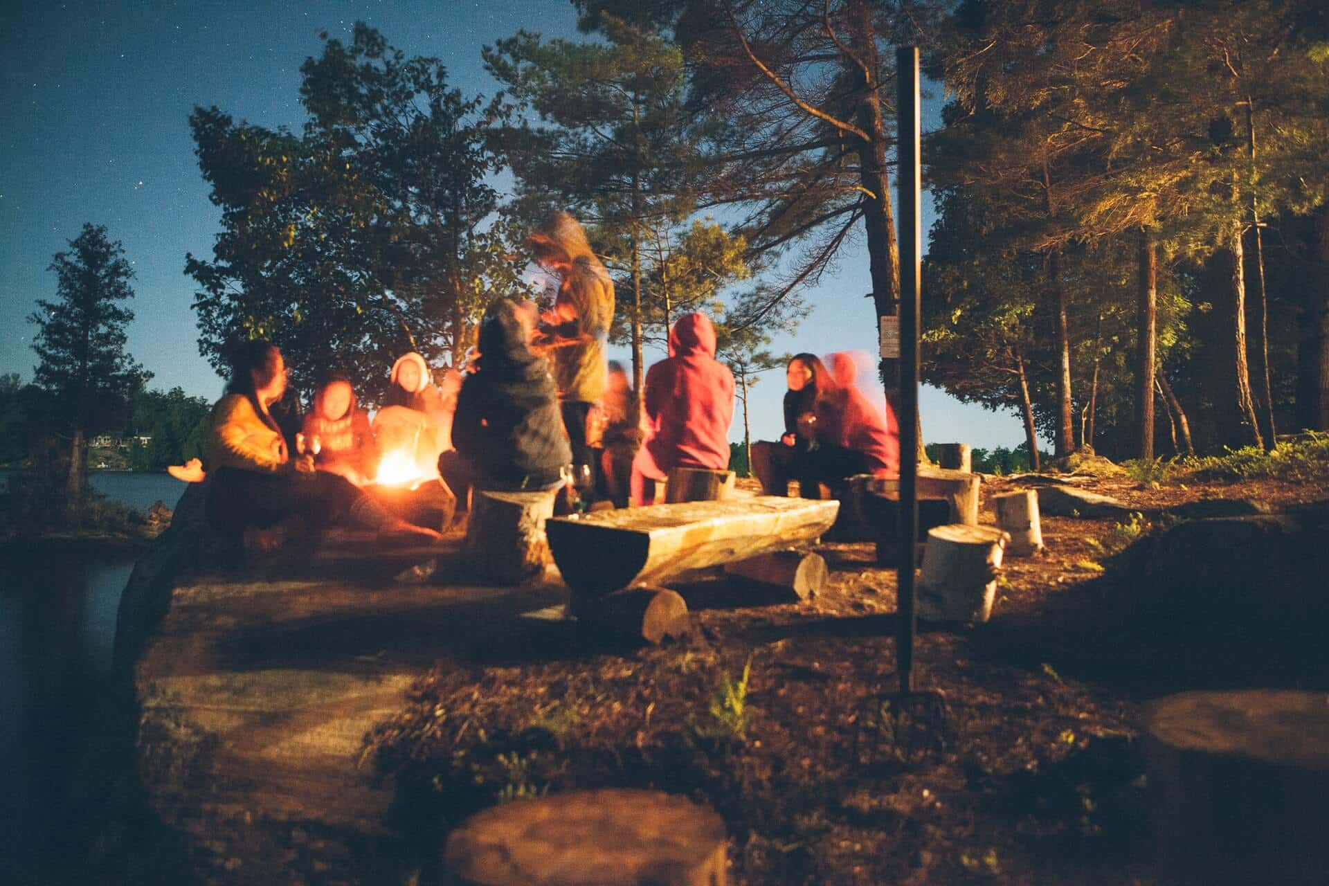 Family and friends sitting around a campfire