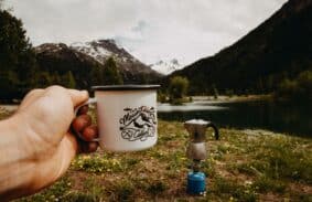 A mug and coffee pot in the wilderness