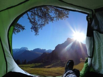 View of nature and mountains from a tent door.