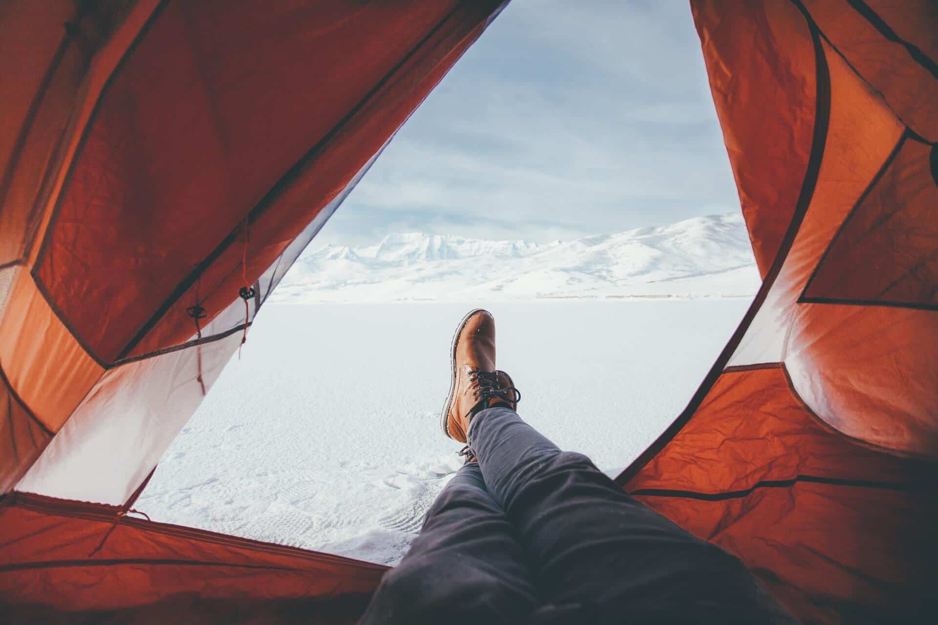 View out of a tent product into snow during a winter camping outdoor experience