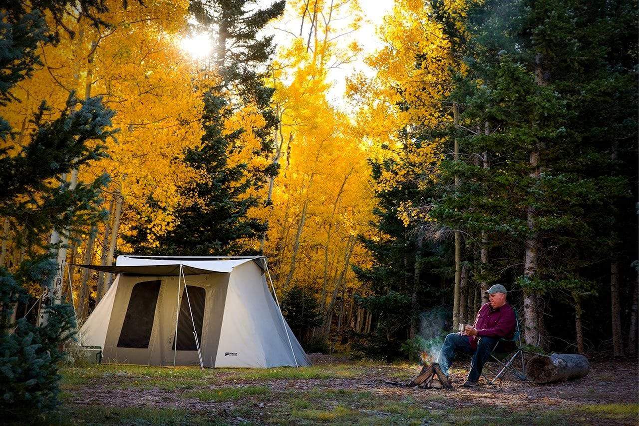 A man sitting by his Kodiak Flex-Bow tent