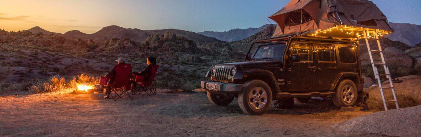 A couple romantic camping in a jeep outdoors
