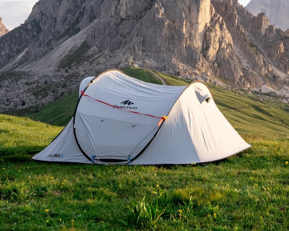 A pop up tent in an alpine environment.