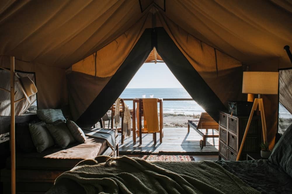 Canvas Glamping Tent with a deck overlooking a beach