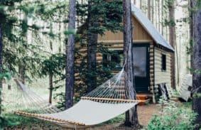 A family cabin set up with a hammock tent in front