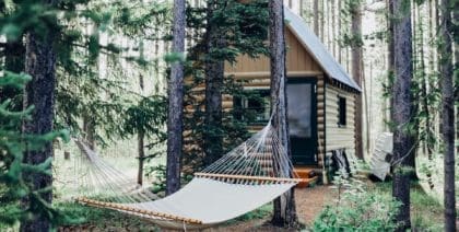 A family cabin set up with a hammock tent in front