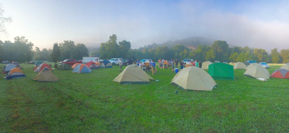 Large group of tents in a paddock in the early morning