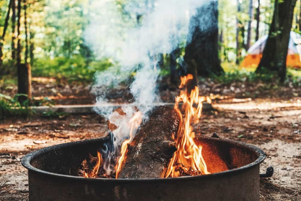 Campfire in a metal drum at a campsite