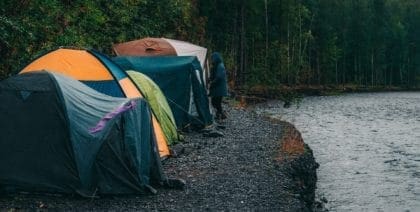 Tents Beside River Camping In Rain
