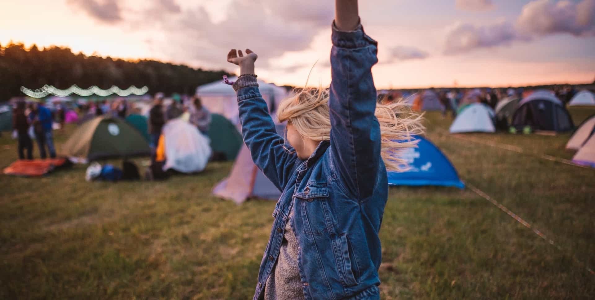 Woman Dancing In Front Of Instant Tent At Festival