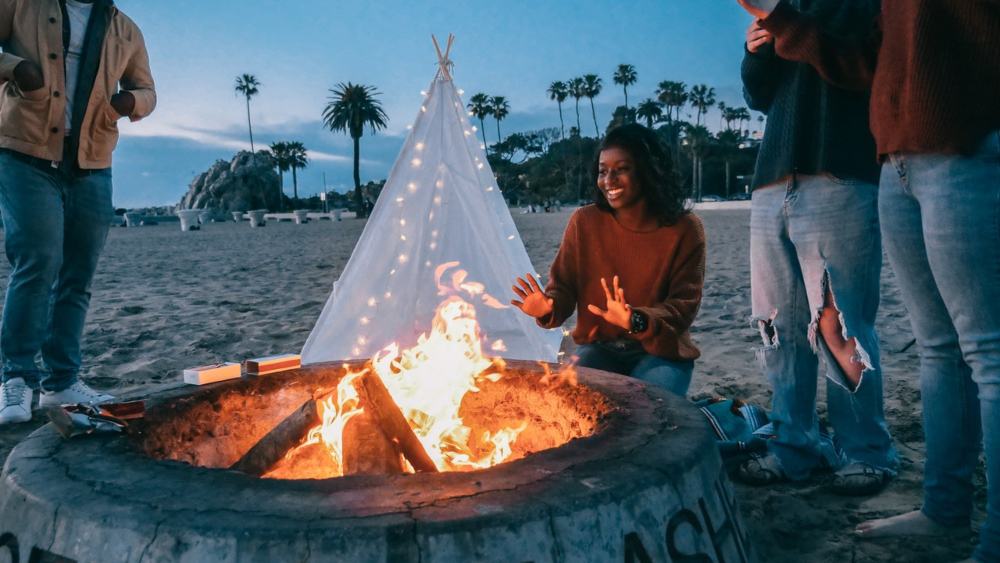 Group of friends Warming their Hands Beside a Campfire