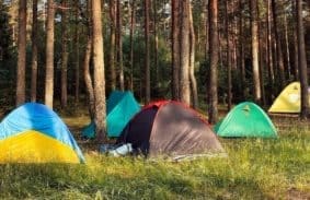 Different types of tents set up for camping outdoors