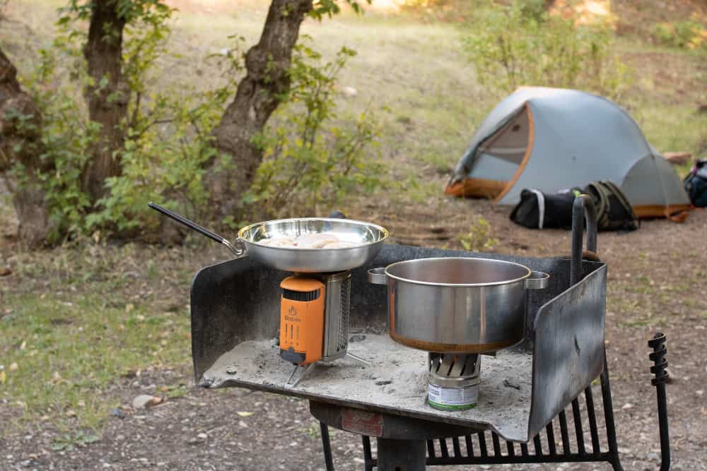 Dont cook inside your tent. Most of them are very flammable and condensation will then be the least of your problems. 